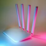 A sleek wireless router enhanced by vibrant neon lights, showcasing cutting-edge technology.
